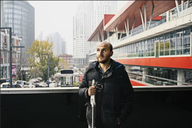 WeWALK Inventor holding smart cane
