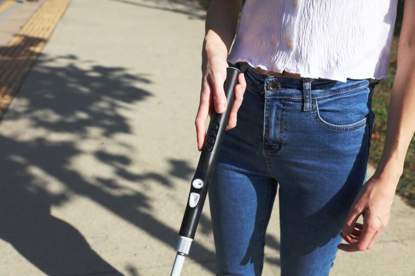Woman Holding Black WeWALK Handle
